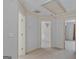 Bright hallway with neutral carpet, trim, and paint provides access to multiple rooms and the attic at 1500 Royce Dr, Locust Grove, GA 30248