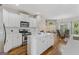 Spacious open concept kitchen with white cabinets, island, modern appliances and dark hardwood floors at 1500 Royce Dr, Locust Grove, GA 30248