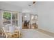 Relaxing living room with plush armchair, large window and view leading to the dining area and kitchen at 1500 Royce Dr, Locust Grove, GA 30248