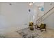 Living room featuring soaring ceilings, two arm chairs and a large area rug at 1500 Royce Dr, Locust Grove, GA 30248