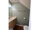 Well-lit half bathroom with a vanity and a toilet adds convenience and functionality at 187 London Dr, Mcdonough, GA 30253