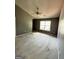 Spacious bedroom featuring a ceiling fan and a large window for natural light at 187 London Dr, Mcdonough, GA 30253