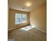 Bright bedroom with a large window and neutral carpet offers a comfortable retreat at 187 London Dr, Mcdonough, GA 30253