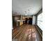 Open dining area with wood floors near the kitchen with natural light from large window at 187 London Dr, Mcdonough, GA 30253