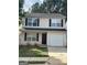 Traditional two-story home with a garage and neutral-toned siding offers great curb appeal at 187 London Dr, Mcdonough, GA 30253