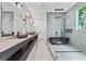 Modern bathroom with marble tile, dual vanity, a luxurious soaking tub and contemporary lighting fixtures at 292 Highway 279, Fayetteville, GA 30215