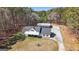 Aerial view of the property showcasing the home, garage, and wooded surroundings at 1185 Old Greenville Rd, Fayetteville, GA 30215