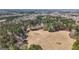 Expansive aerial shot showing the property's boundaries and natural landscape with forests and fields at 1185 Old Greenville Rd, Fayetteville, GA 30215