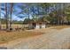 Exterior view of a metal barn with a gated enclosure, perfect for livestock or storage at 1185 Old Greenville Rd, Fayetteville, GA 30215