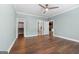 Bedroom with wood floors, modern ceiling fan, neutral light blue walls and view of fireplace at 1185 Old Greenville Rd, Fayetteville, GA 30215