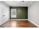 This bedroom features a horizontal wood accent wall, wood floors, and large closet at 1185 Old Greenville Rd, Fayetteville, GA 30215