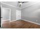 Bright bedroom featuring wood floors, modern ceiling fan and neutral gray walls at 1185 Old Greenville Rd, Fayetteville, GA 30215