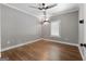 Spacious bedroom featuring wood floors, modern ceiling fan and neutral gray walls at 1185 Old Greenville Rd, Fayetteville, GA 30215