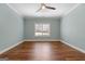 This bedroom features wood floors, modern ceiling fan and neutral light blue walls at 1185 Old Greenville Rd, Fayetteville, GA 30215