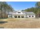 Inviting front exterior with a covered porch featuring ceiling fans and comfortable benches at 1185 Old Greenville Rd, Fayetteville, GA 30215