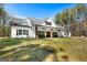 Lovely farmhouse with a covered porch, ceiling fans, benches, and a well-manicured lawn at 1185 Old Greenville Rd, Fayetteville, GA 30215