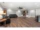 Spacious living room featuring a brick fireplace with built-ins, leather couches, and a unique ceiling fan at 1185 Old Greenville Rd, Fayetteville, GA 30215