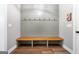 Hallway mudroom features a wooden bench with storage, shiplap wall paneling with hooks, and wood look flooring at 1185 Old Greenville Rd, Fayetteville, GA 30215