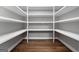 Well-organized walk-in pantry with white shelving and wood look flooring at 1185 Old Greenville Rd, Fayetteville, GA 30215