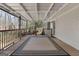 Back deck includes a covered roof, decorative rug, and view into the wooded backyard at 135 Flat Creek Ct, Fayetteville, GA 30214