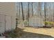 Fenced backyard showing a shed and a partially shaded yard with mature trees at 135 Flat Creek Ct, Fayetteville, GA 30214