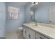 Charming blue bathroom with white vanity, toilet, and natural light from a window at 135 Flat Creek Ct, Fayetteville, GA 30214