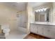 Bathroom featuring a dual sink vanity, a walk-in shower and tile floors at 135 Flat Creek Ct, Fayetteville, GA 30214