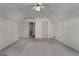 Spacious bedroom with carpet, ceiling fan, and access to another room at 135 Flat Creek Ct, Fayetteville, GA 30214