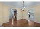 Open dining area featuring hardwood floors, view to staircase, chandelier, and easy access to the kitchen at 135 Flat Creek Ct, Fayetteville, GA 30214