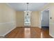 Elegant dining room with hardwood floors, chandelier, and window with natural light at 135 Flat Creek Ct, Fayetteville, GA 30214