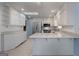 Bright kitchen featuring white cabinets, stainless steel appliances, and a skylight for natural light at 135 Flat Creek Ct, Fayetteville, GA 30214