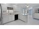 Kitchen with white cabinetry, and stainless steel appliances, that flows into an adjacent dining area at 135 Flat Creek Ct, Fayetteville, GA 30214