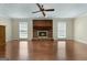 Spacious living room features a brick fireplace and hardwood floors, creating a cozy atmosphere at 135 Flat Creek Ct, Fayetteville, GA 30214