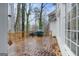 Back deck perfect for outdoor dining with a grill, table and chairs at 365 Falling Creek Bnd, Johns Creek, GA 30097