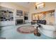 Bright living room with a fireplace, built-in shelves, and a view of the second-story landing at 365 Falling Creek Bnd, Johns Creek, GA 30097