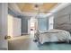 Spacious primary bedroom with a tray ceiling, sitting area, and an ensuite bathroom at 365 Falling Creek Bnd, Johns Creek, GA 30097