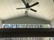 View from a back porch shows a ceiling fan and a wooded background at 85 Crabapple Ridge Dr, Oxford, GA 30054