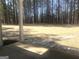 View from a back porch with a path leads to a tree line in a grass covered backyard at 85 Crabapple Ridge Dr, Oxford, GA 30054