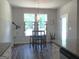 Bright breakfast nook featuring pendant lighting, bar-height table, and windows overlooking the wooded backyard at 85 Crabapple Ridge Dr, Oxford, GA 30054