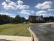 View of community clubhouse with attractive landscaping and surrounding green spaces at 85 Crabapple Ridge Dr, Oxford, GA 30054