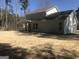 Exterior shot of the back of the home in a neighborhood featuring a grass covered backyard with mature trees at 85 Crabapple Ridge Dr, Oxford, GA 30054