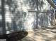Side-entry two car garage with carriage door detail and exterior coach lighting at 85 Crabapple Ridge Dr, Oxford, GA 30054