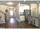 Open-concept kitchen with white cabinets, stainless steel appliances, and view to the home's front entrance at 85 Crabapple Ridge Dr, Oxford, GA 30054