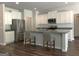 Modern kitchen featuring white cabinets, stainless steel appliances, and a center island with barstool seating at 85 Crabapple Ridge Dr, Oxford, GA 30054