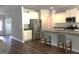 Bright kitchen with white cabinets, stainless steel appliances, and a granite-topped island with bar stools at 85 Crabapple Ridge Dr, Oxford, GA 30054