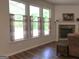 Living room featuring large windows, wood floors, a fireplace and views to the trees outside at 85 Crabapple Ridge Dr, Oxford, GA 30054