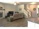 Cozy living room with a fireplace, wood floors, and a comfortable sofa, open to the kitchen and staircase at 85 Crabapple Ridge Dr, Oxford, GA 30054