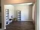 Open-concept living area featuring hardwood floors, neutral paint, and built-in bookshelves at 85 Crabapple Ridge Dr, Oxford, GA 30054