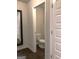A clean powder room shows a toilet with hardwood floors and a doorway that leads to other rooms at 85 Crabapple Ridge Dr, Oxford, GA 30054