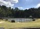 Community tennis courts and playground surrounded by mature trees at 85 Crabapple Ridge Dr, Oxford, GA 30054